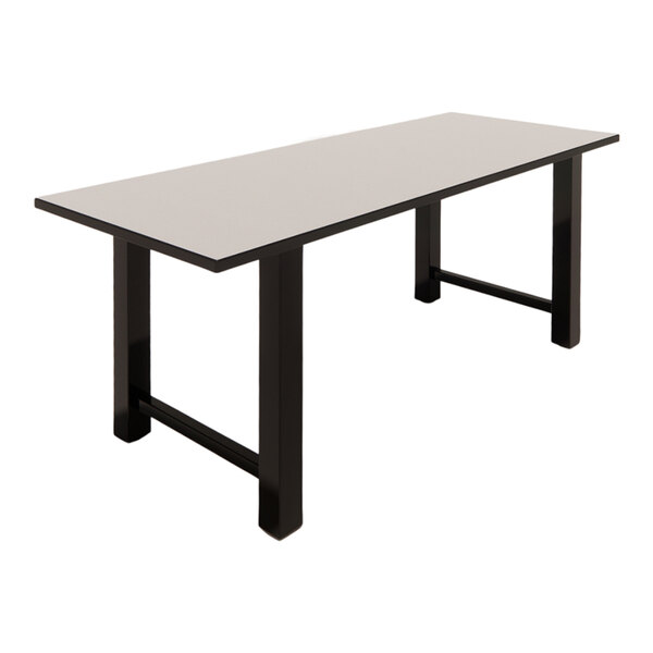 A rectangular table with a white laminate top and black legs.