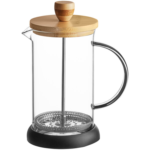 A glass French press with a wooden lid, metal plunger, and a clear handle, standing on a black base.