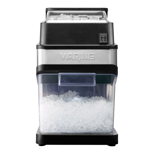 A commercial countertop ice crusher with a clear container filled with crushed ice and the brand name Waring on the front.