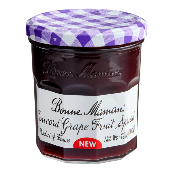 A jar of Bonne Maman Concord Grape Fruit Spread with a purple checkered lid and a white label, containing 12.7 oz.