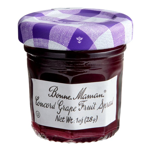A small glass jar of Bonne Maman Concord Grape Fruit Spread with a purple and white checkered lid.