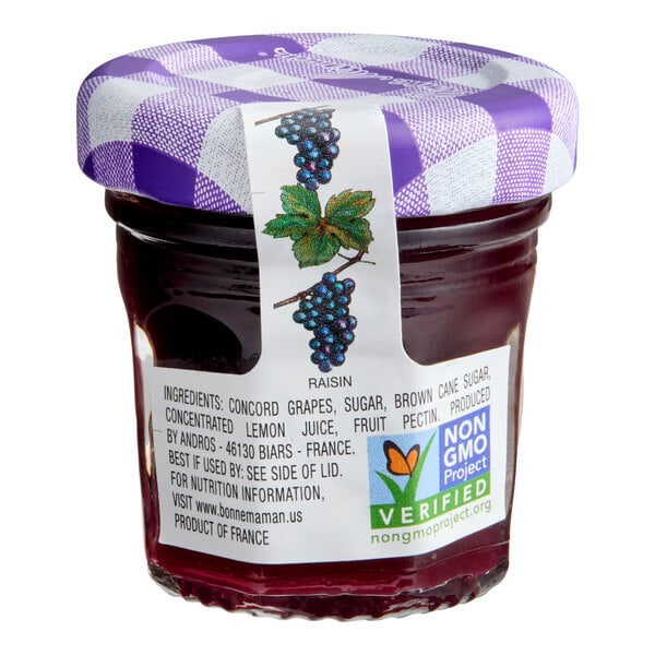 A small glass jar of Bonne Maman Concord Grape Fruit Spread with a purple checkered lid and product label.
