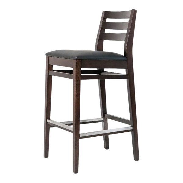 A dark brown beech wood bar stool with a ladder back design and a black faux leather seat.