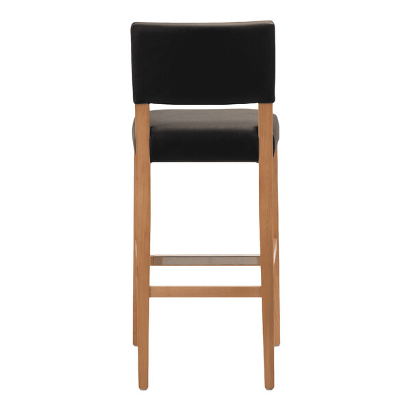 A bar stool with a natural beech wood frame and a black faux leather seat and backrest.