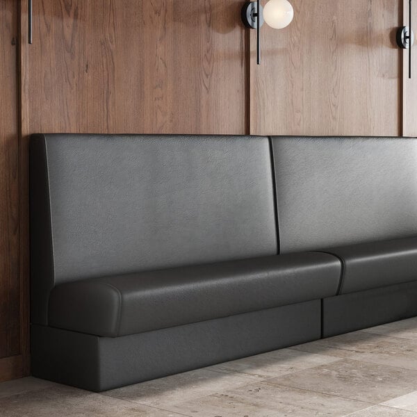 A long, black upholstered wall booth banquette with a high backrest and plain design.