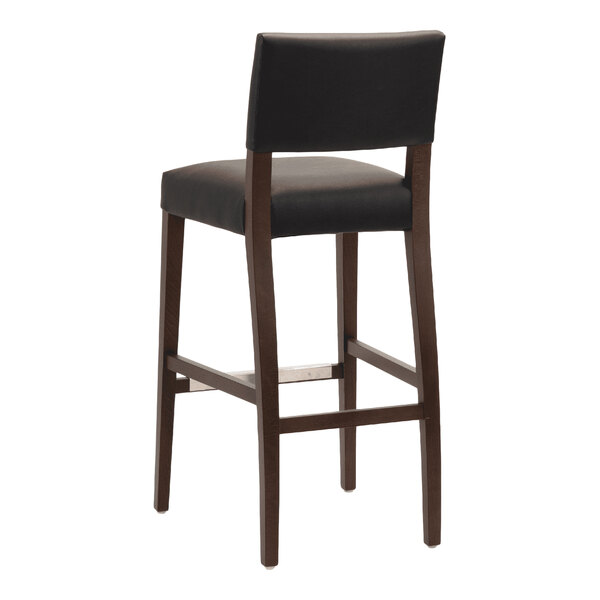 A dark brown beech wood bar stool with a black faux leather seat and backrest.