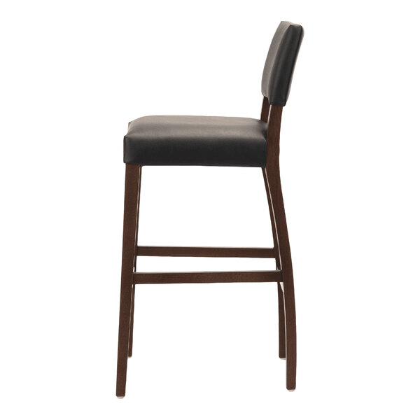 A dark brown beech wood bar stool with a black faux leather seat and backrest.