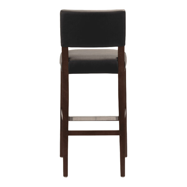 A dark brown beech wood bar stool with a black faux leather seat and back.