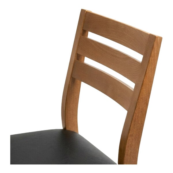 A natural beech wood ladder back dining chair with a black faux leather seat.