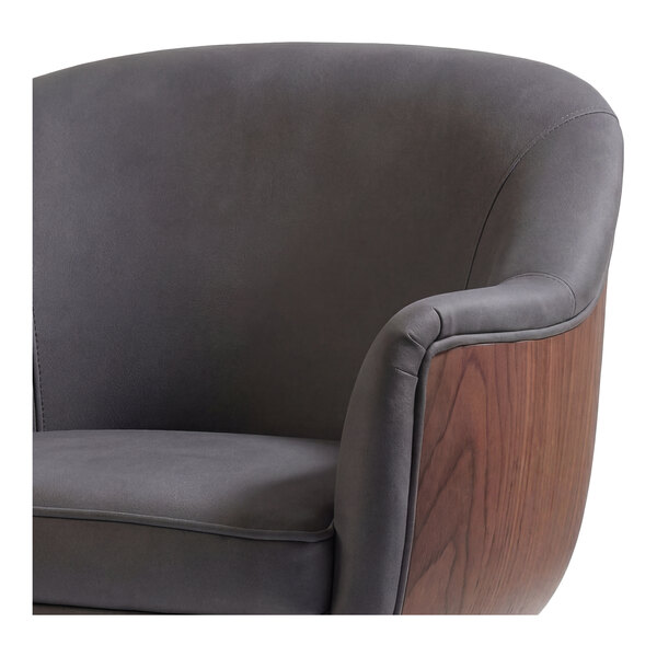 A gray faux leather arm chair with a rounded black wooden frame.