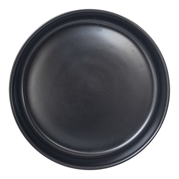 A round porcelain plate with a matte black finish and a slightly raised rim.
