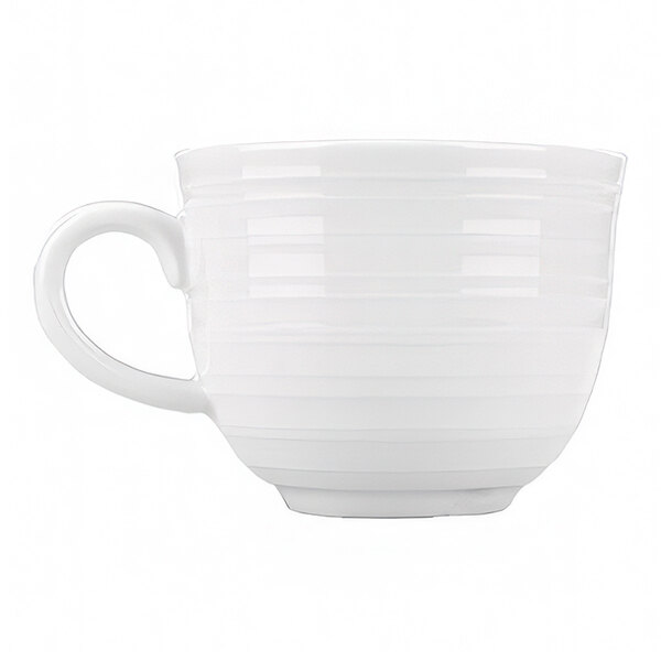 A small, bright white porcelain cup with a handle.