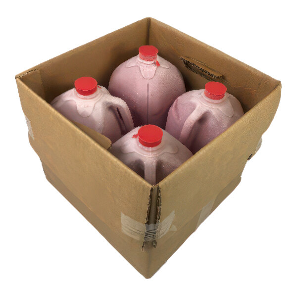 A cardboard box containing four one-gallon jugs of strawberry banana smoothie concentrate with red caps.