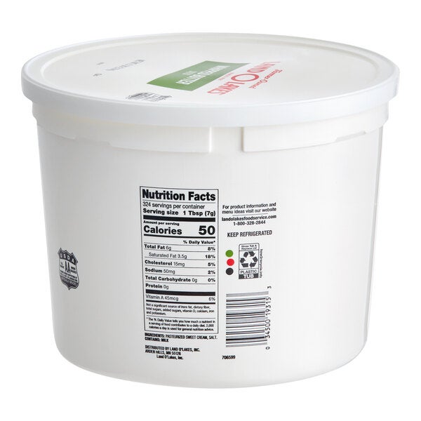 A large white plastic tub of Land O Lakes salted whipped butter with a lid and nutrition facts label.
