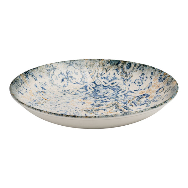 A round blue and white porcelain flat coupe deep plate with tan accents and an organic foliate design.
