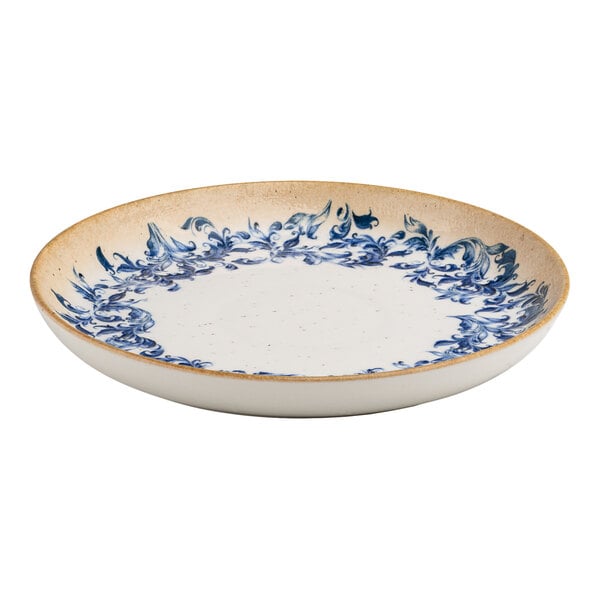 A round white porcelain plate with a blue floral edge design and a tan rim.