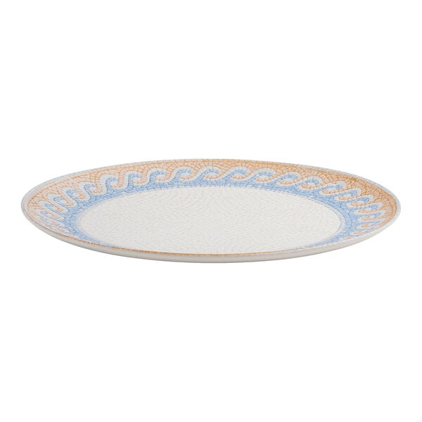 An oval white porcelain platter with a blue and tan wave design around the rim.