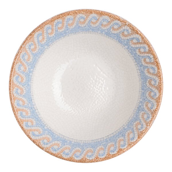 A round white porcelain bowl with a blue and tan wave design around the rim.