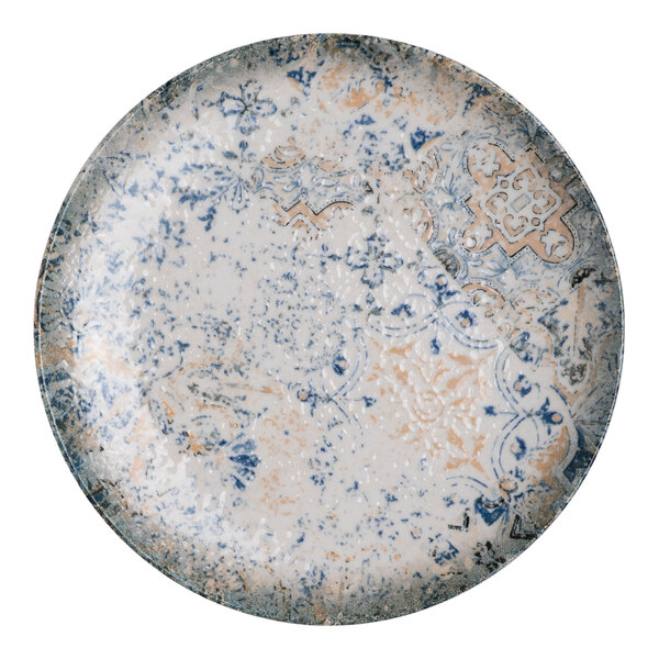 A round blue and white porcelain flat coupe plate with tan accents and an organic foliate design.
