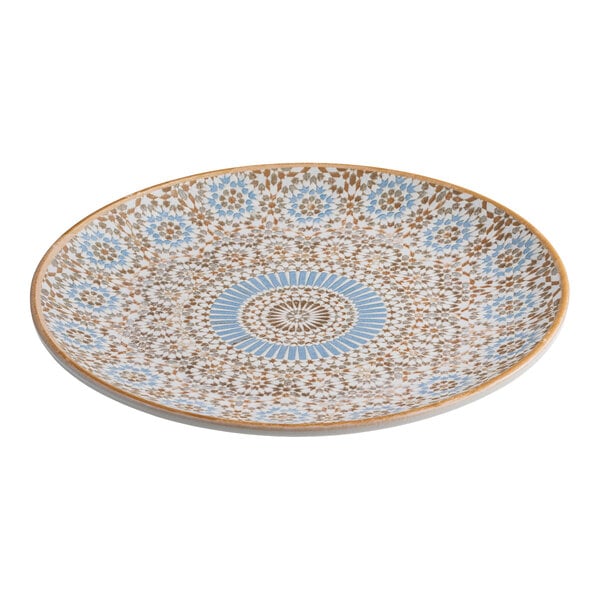 A round porcelain plate with a blue and orange radial geometric design.