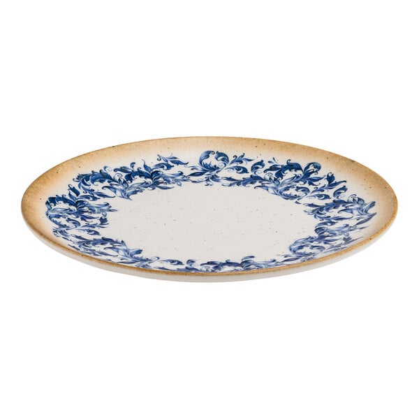 A round white porcelain plate with a blue floral edge and a tan rim.