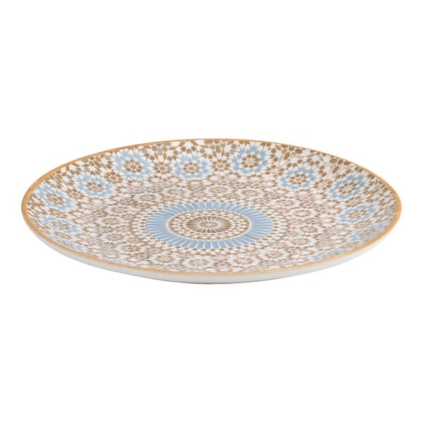 A round porcelain plate with a blue and orange radial geometric design.