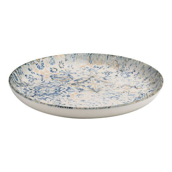 A round blue and white porcelain flat coupe plate with tan accents and an organic foliate design.