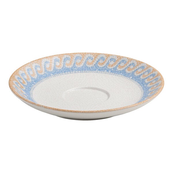 A round white porcelain saucer with a blue and tan wave design around the rim.