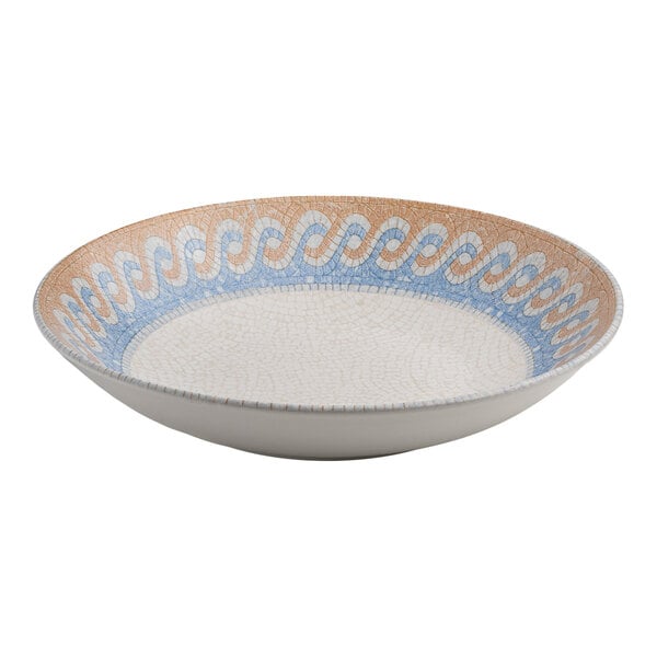 A round white porcelain deep coupe plate with a blue and tan wave design along the rim.