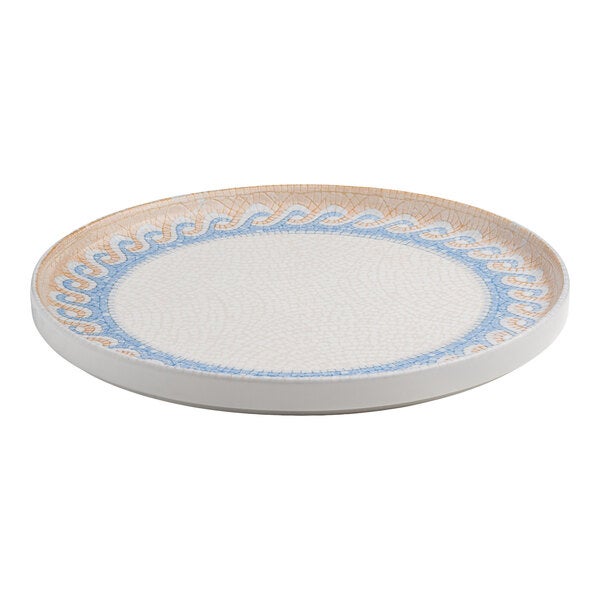 A round white porcelain plate with a raised rim and a blue and tan wave design along the border.