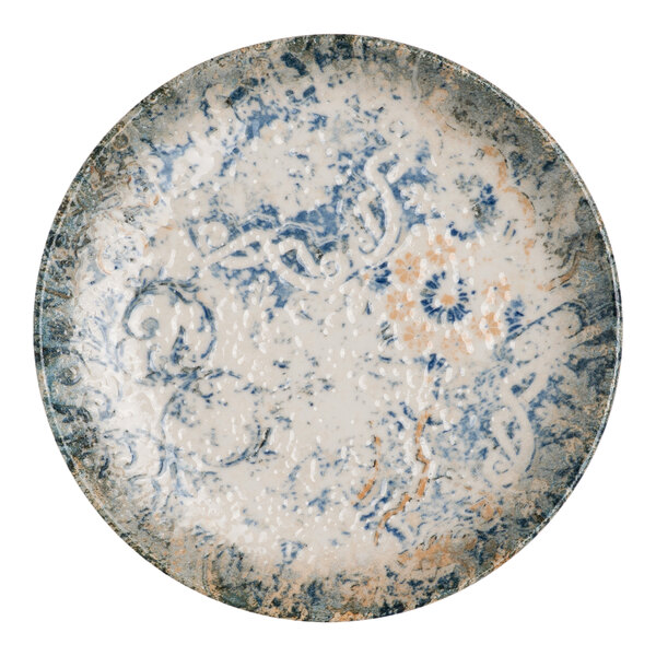 A round blue and white porcelain flat coupe plate with tan accents and an organic foliate design.