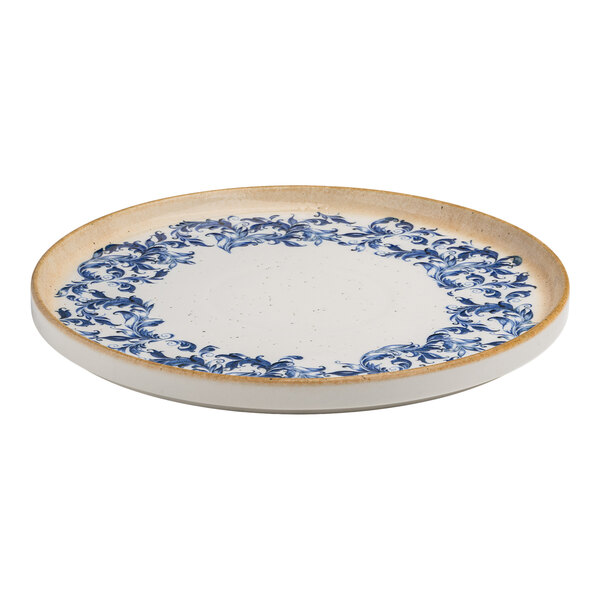 A round white porcelain plate with a blue floral edge design and a tan raised rim.