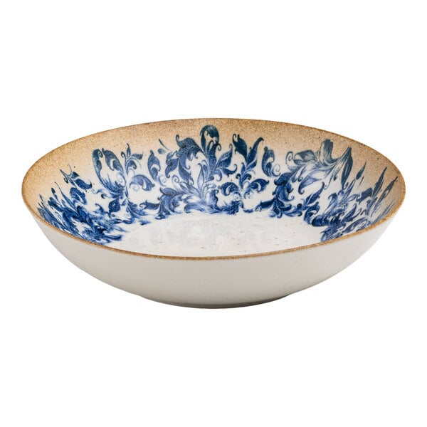 A round white porcelain deep coupe plate with a blue floral center design and a tan rim.