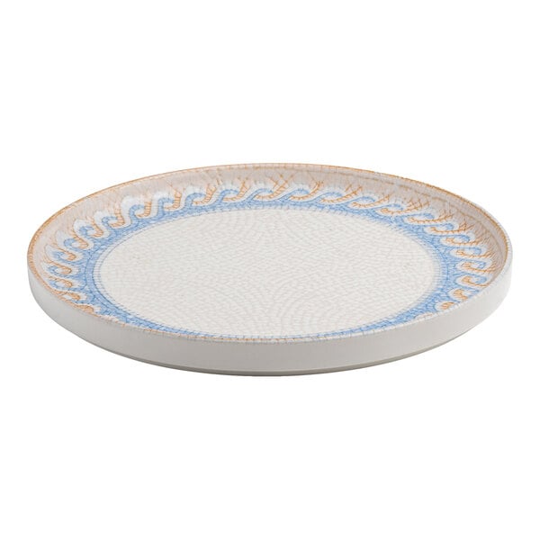 A round white porcelain plate with a raised rim and a blue and tan wave design near the edge.