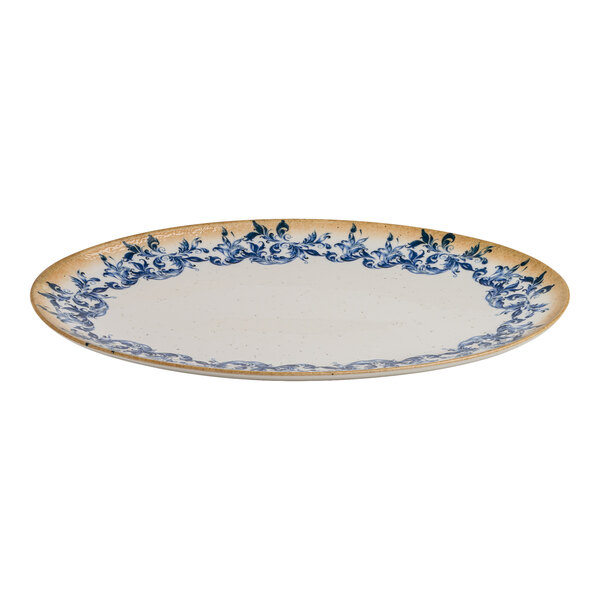 An oval white porcelain platter with a blue floral edge and a tan rim.