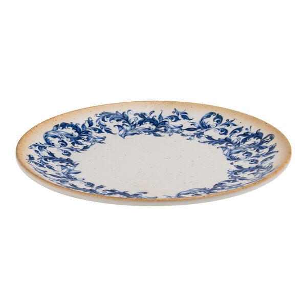 A round white porcelain plate with a blue floral edge and a tan rim.