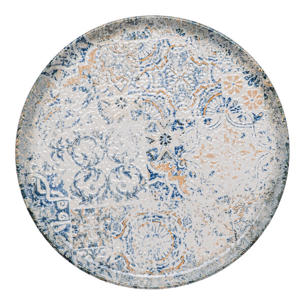 A round blue and white porcelain plate with tan accents and an organic foliate design.