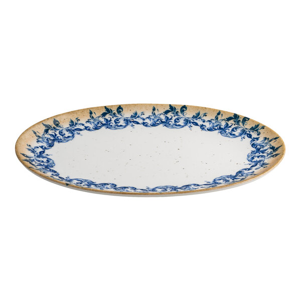 An oval white porcelain platter featuring a blue floral edge and a tan rim.