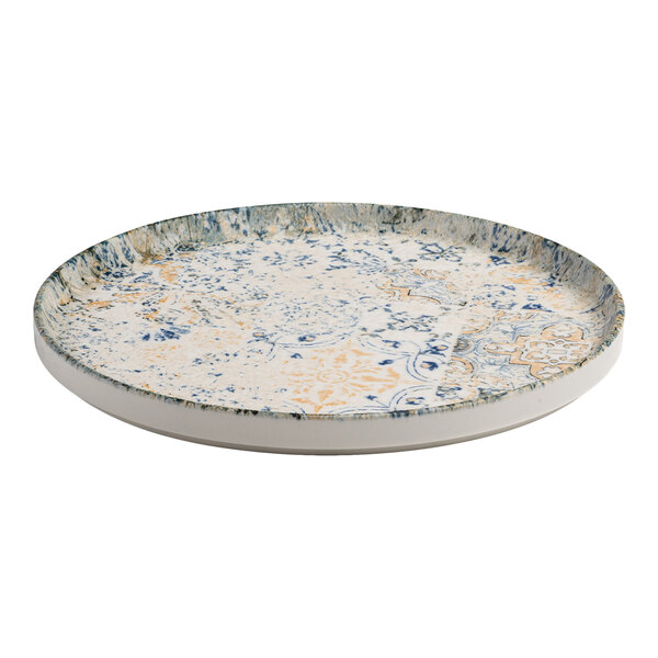 A round porcelain plate with a raised rim, featuring a blue, white, and tan organic foliate design.