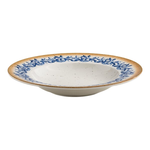 A round white porcelain bowl with a blue floral pattern near the center and a tan rim.