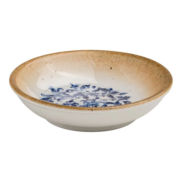 A round white porcelain deep coupe plate with a blue floral center and a tan rim.