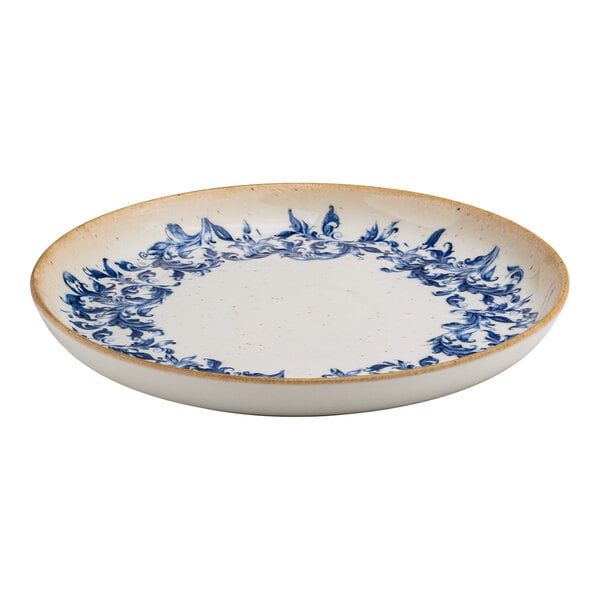 A round white porcelain plate with a blue floral edge design and a tan rim.