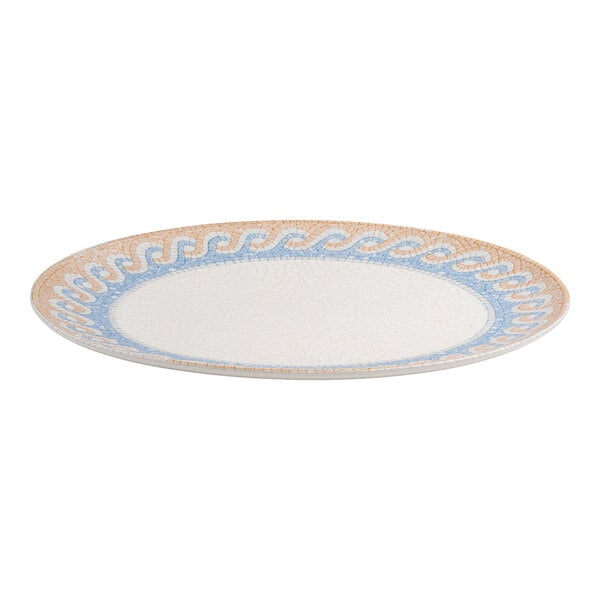 An oval white porcelain platter with a blue and tan wave design around the rim.