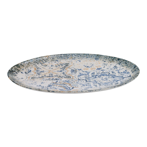 An oval blue and white porcelain platter with tan accents and an organic foliate design.