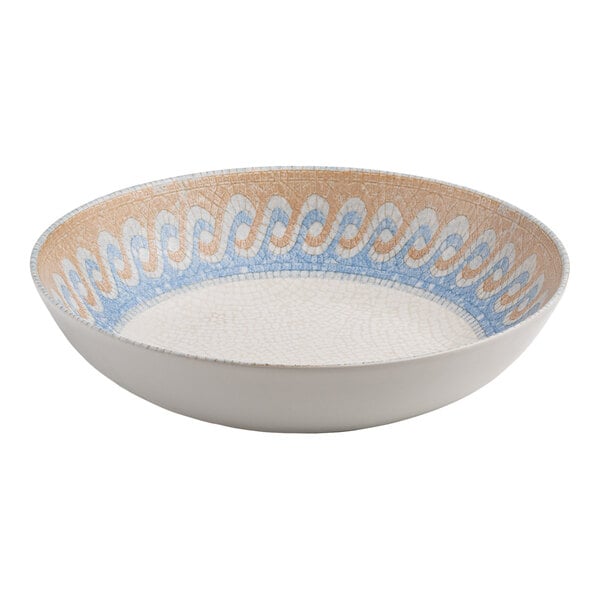 A round white porcelain deep coupe plate with a blue and tan wave design on the interior.