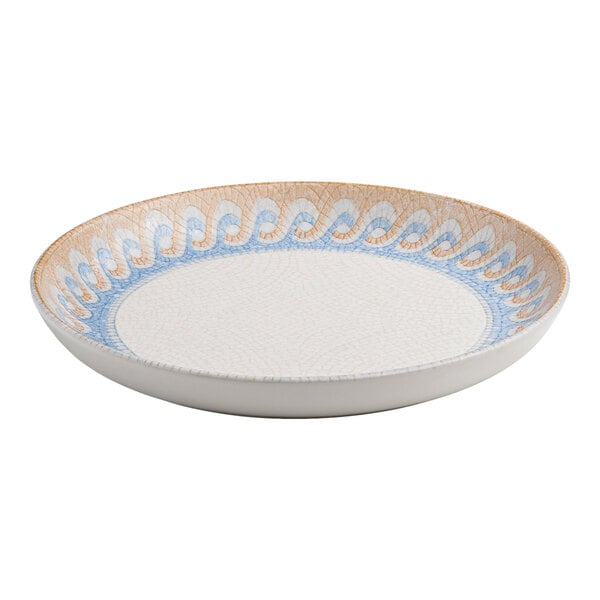 A round white porcelain flat coupe plate with a blue and tan wave design along the rim.