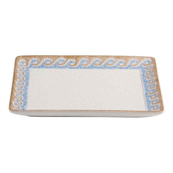 A square white porcelain plate with a blue and tan wave design border.
