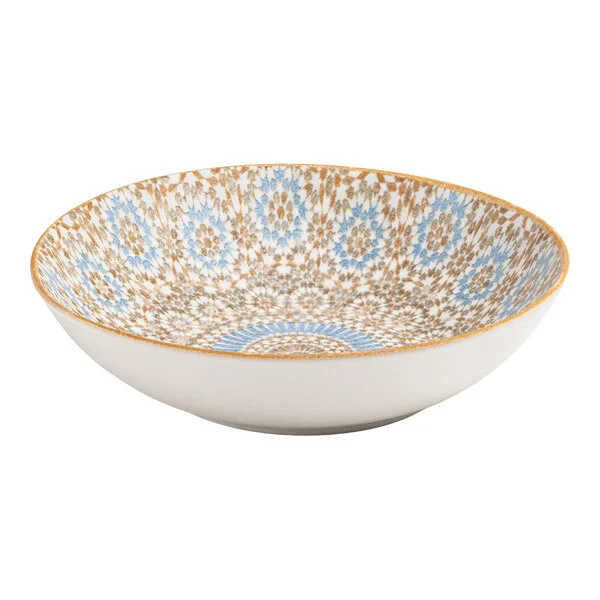 A round porcelain deep coupe plate with a blue and orange radial geometric design on the interior.