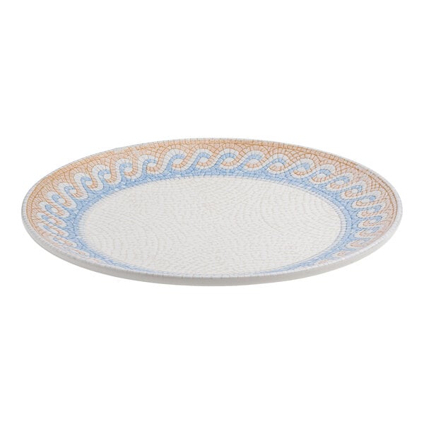 A round white porcelain rimless coupe plate with a blue and tan wave design around the edge.