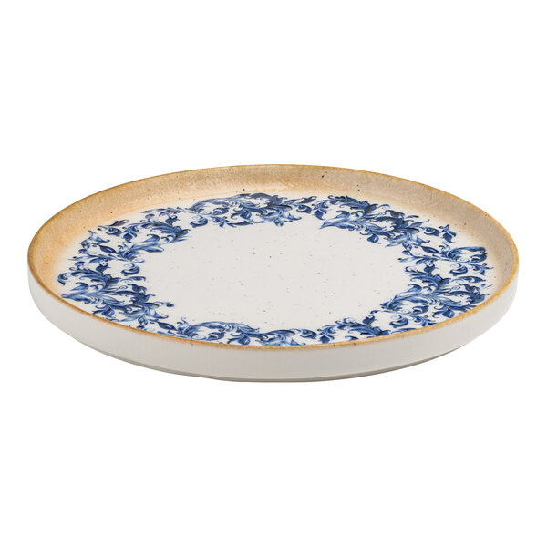 A round white porcelain plate with a blue floral edge design and a tan raised rim.